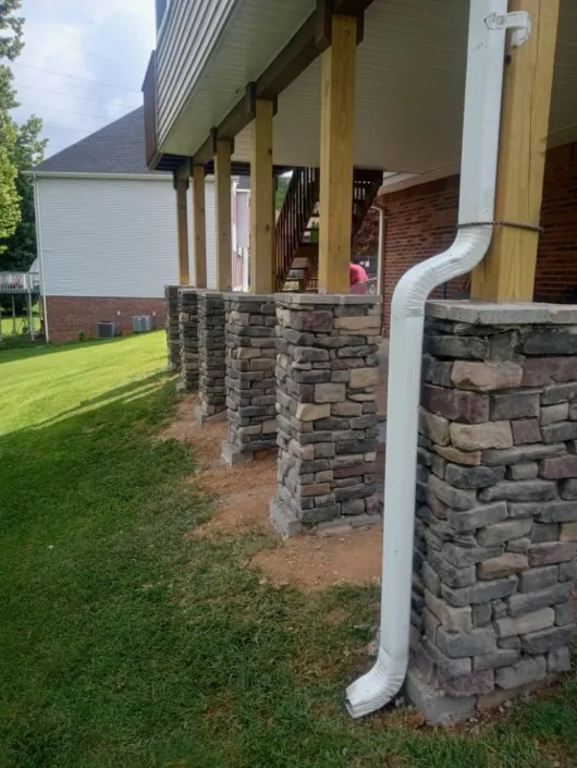 Stone masonry columns beside a raised porch